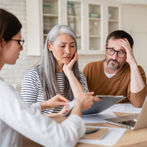 Concerned senior couple discussing estate planning mistakes with a professional in Oklahoma.